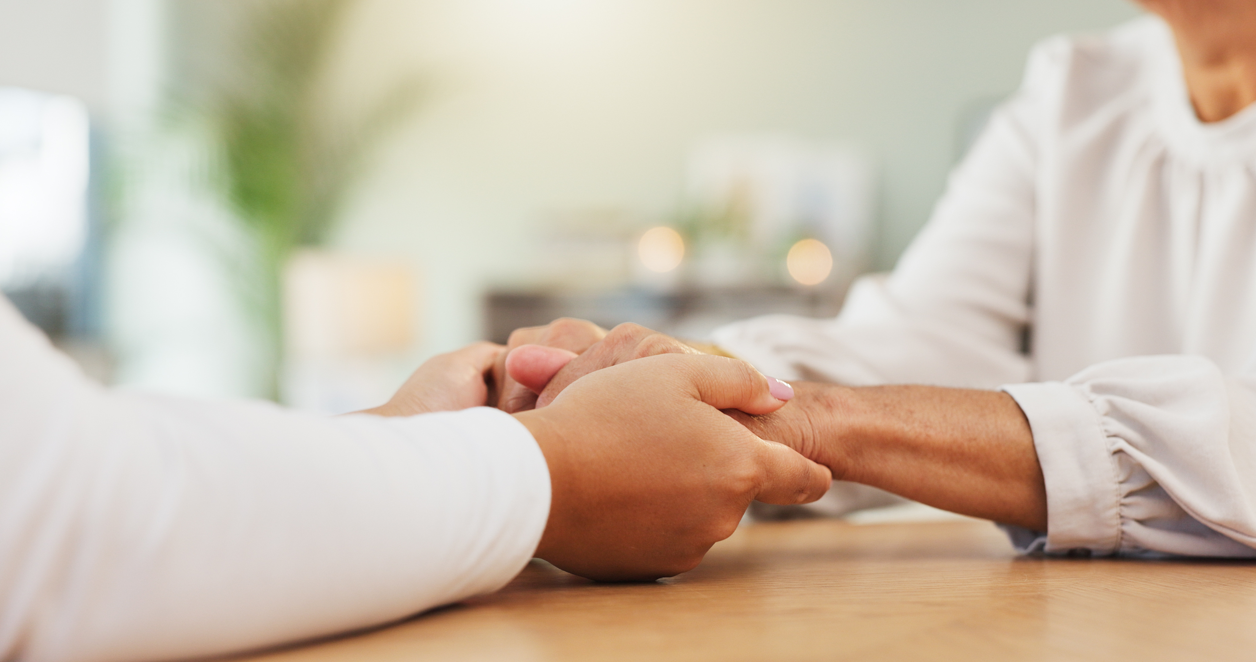 Two people holding hands in comfort