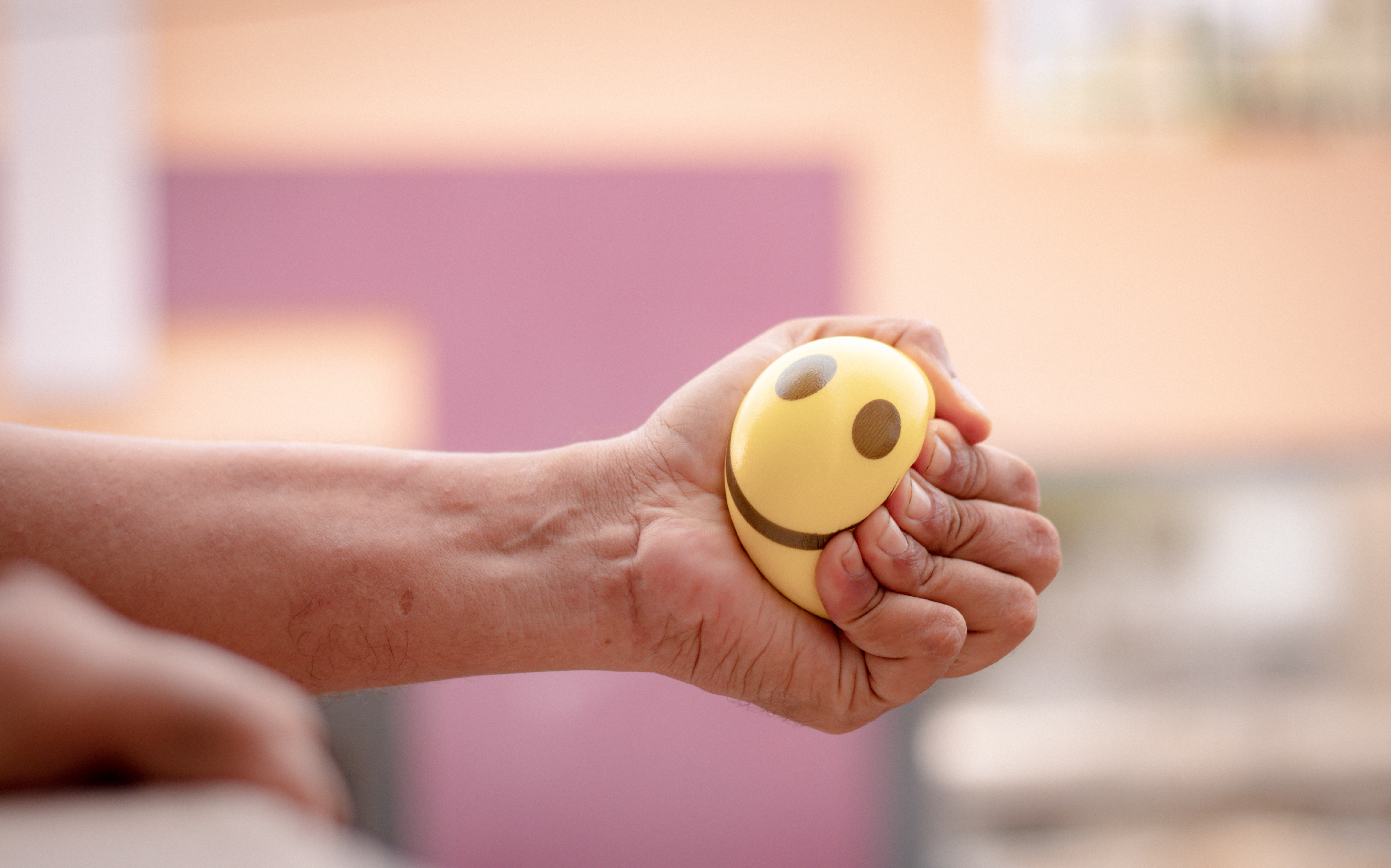 Person squeezing a stress ball