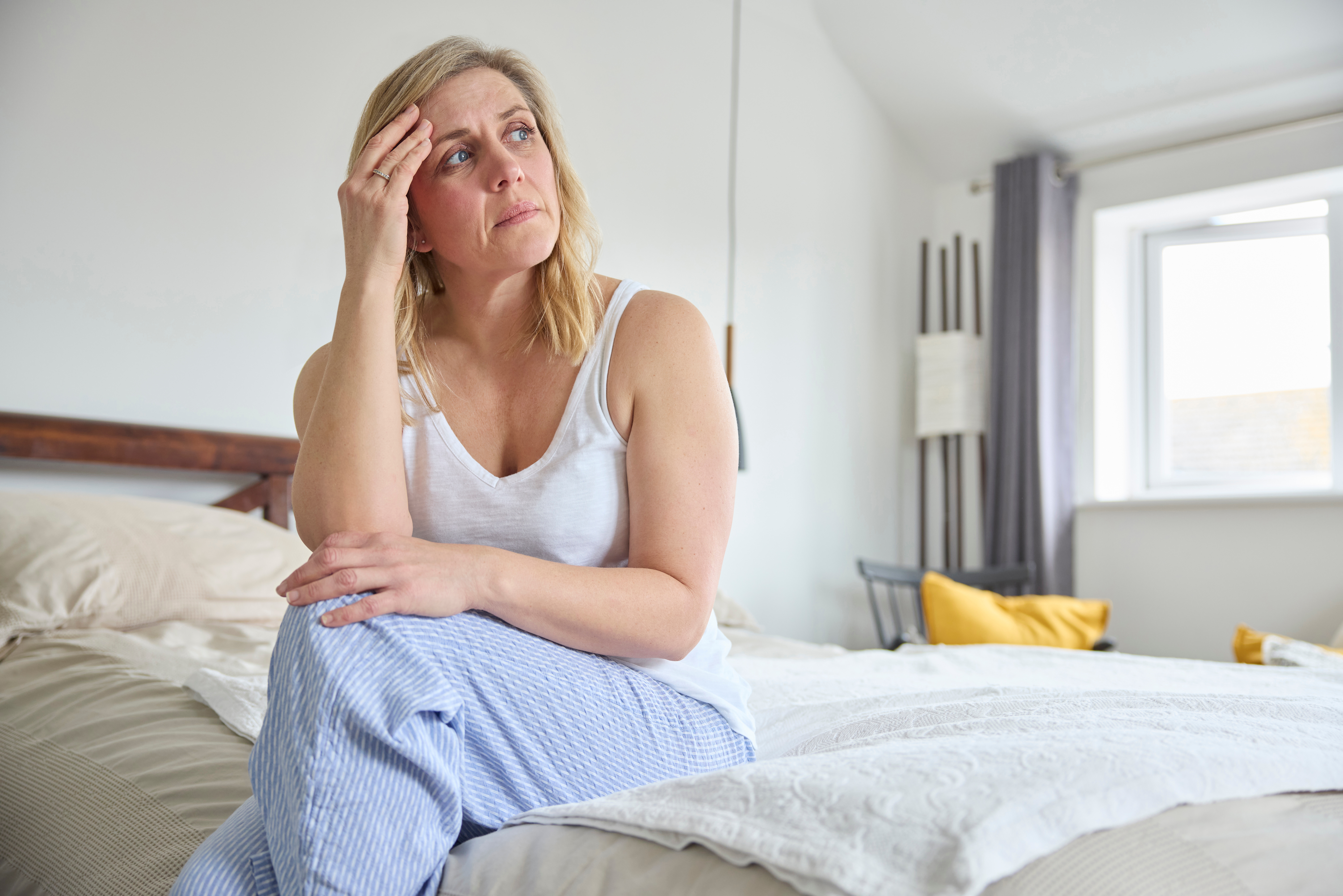 Person sitting alone looking distressed